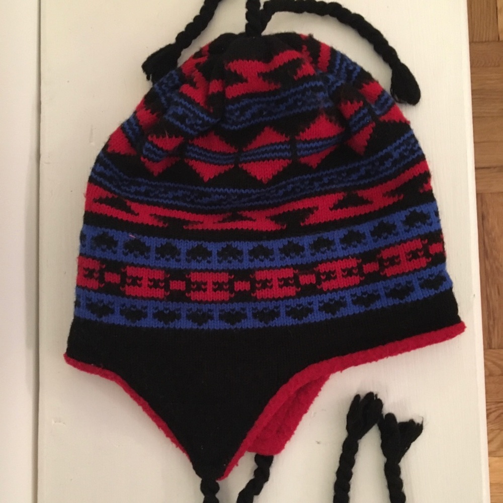 Black, blue, red winter hat with ear flaps.